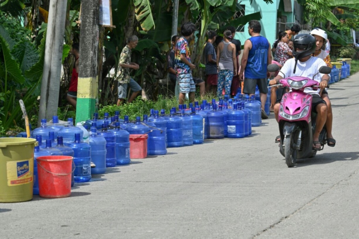 People queued for water after a deadly earthquake in the central Philippines wrecked infratsructure, cut water and power and left thousands homeless