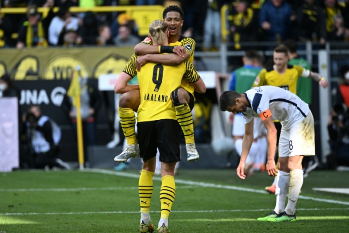 Jude Bellingham embraces former Borussia Dortmund teammate Erling Haaland. The two won the German Cup with Dortmund in 2021.