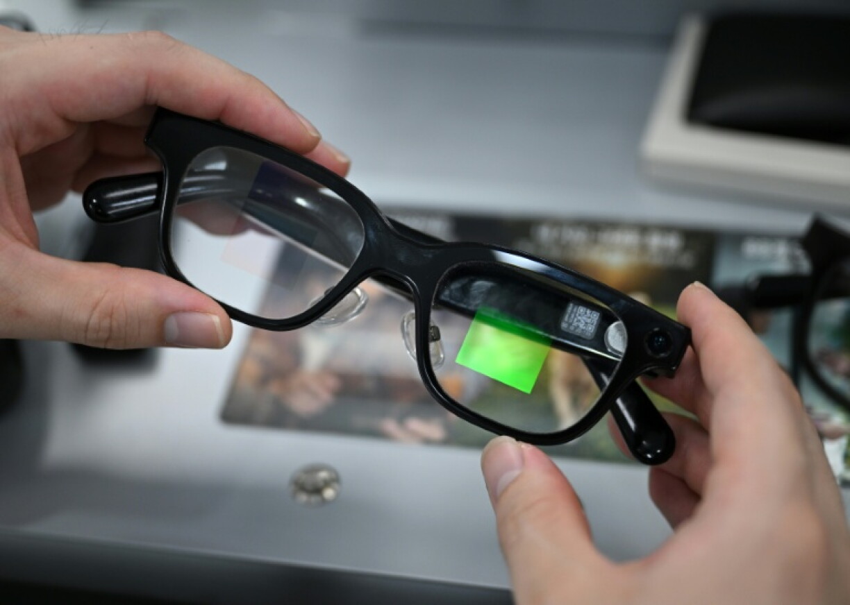 An optometrist holds a pair of smart glasses at the Eyedaq eyewear store in Seoul on Friday