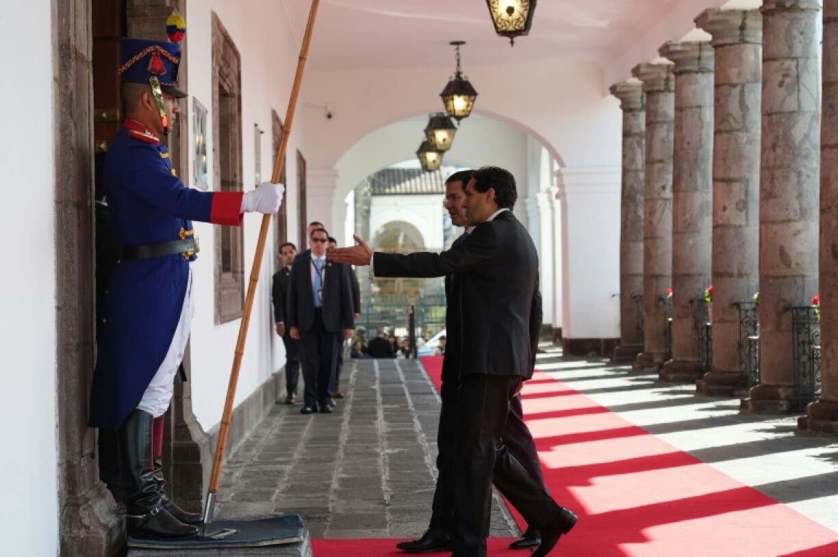 A protocol officer accompanies US Secretary of State Marco Rubio to a meeting with Ecuador's President Daniel Noboa in Quito