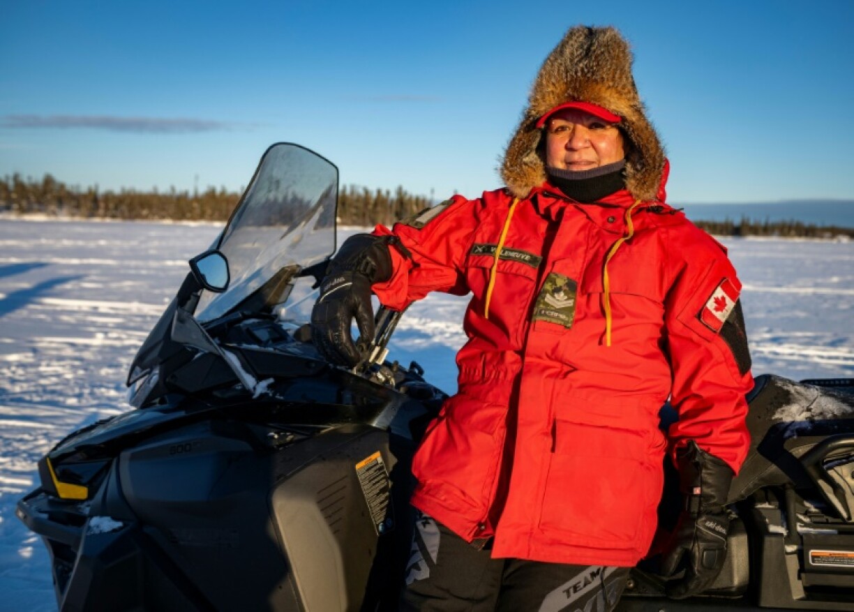 Master Corporal Lorraine Villeneuve, a Canadian Ranger for 20 years, rides a snowmobile in Canada's Northwest Territories