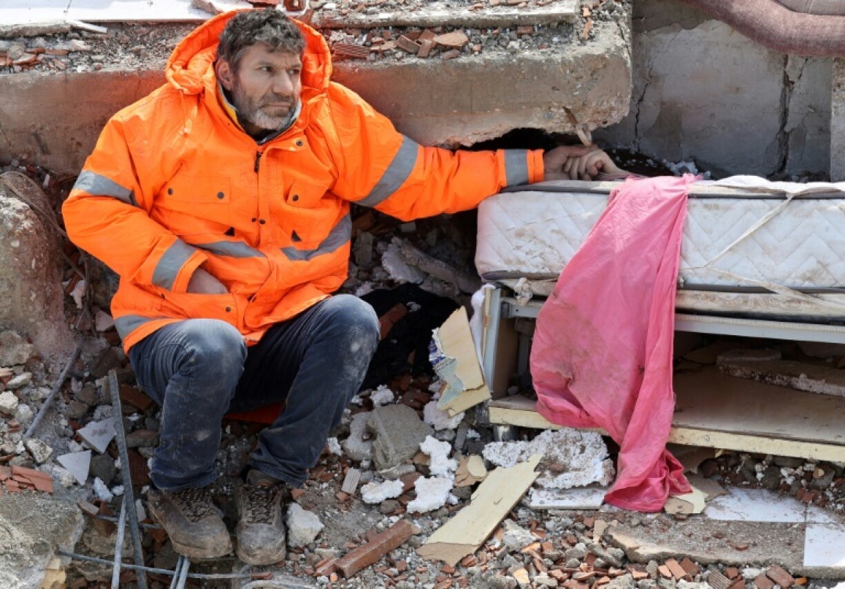 Mesut Hancer holds the hand of his 15-year-old daughter Irmak who died under the rubble in Kahramanmaras