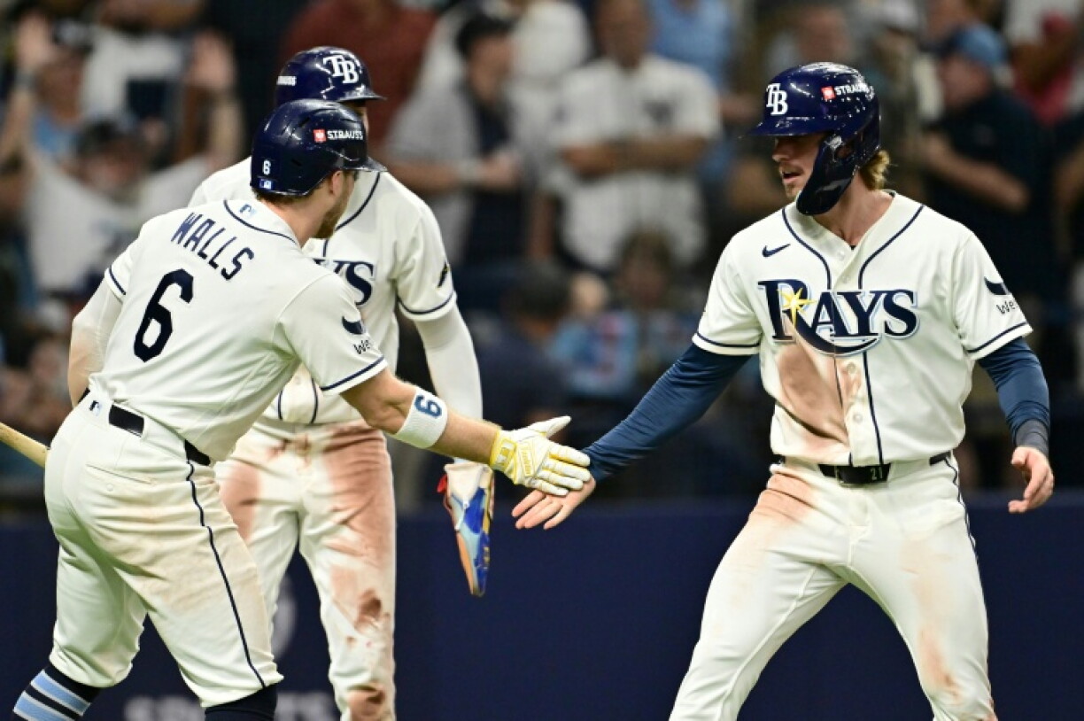 Tampa Bay's Jonny DeLuca celebrates with teammate Taylor Walls after scoring a run against the New York Yankees in their game two victory