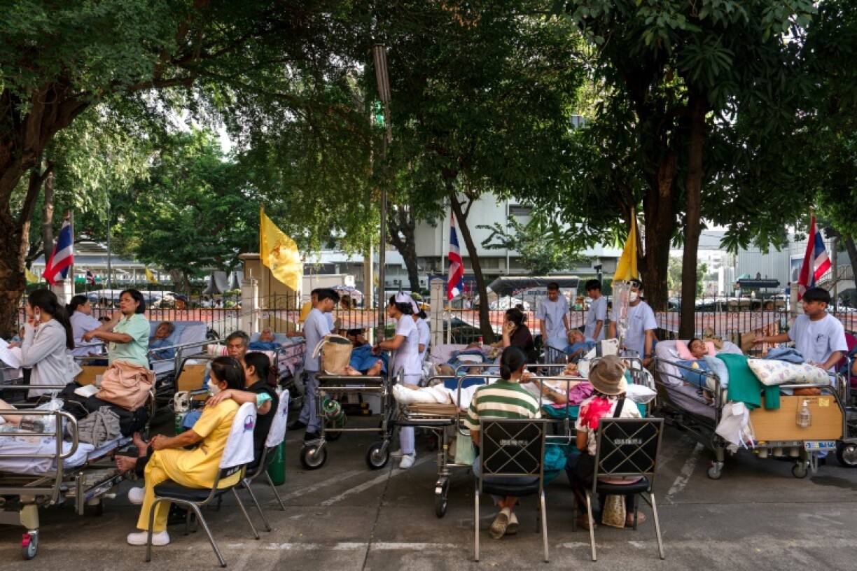 Patients lie on beds in the compound of Bangkok's Phramongkutklao Hospital following the earthquake