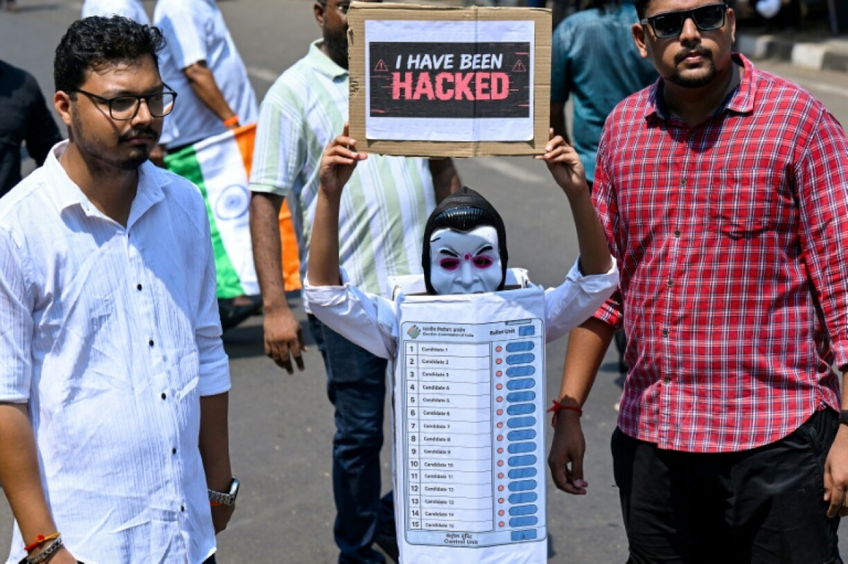 Protesters carry placards during a demonstration calling for the resignation of India's Chief Election Commissioner Gyanesh Kumar