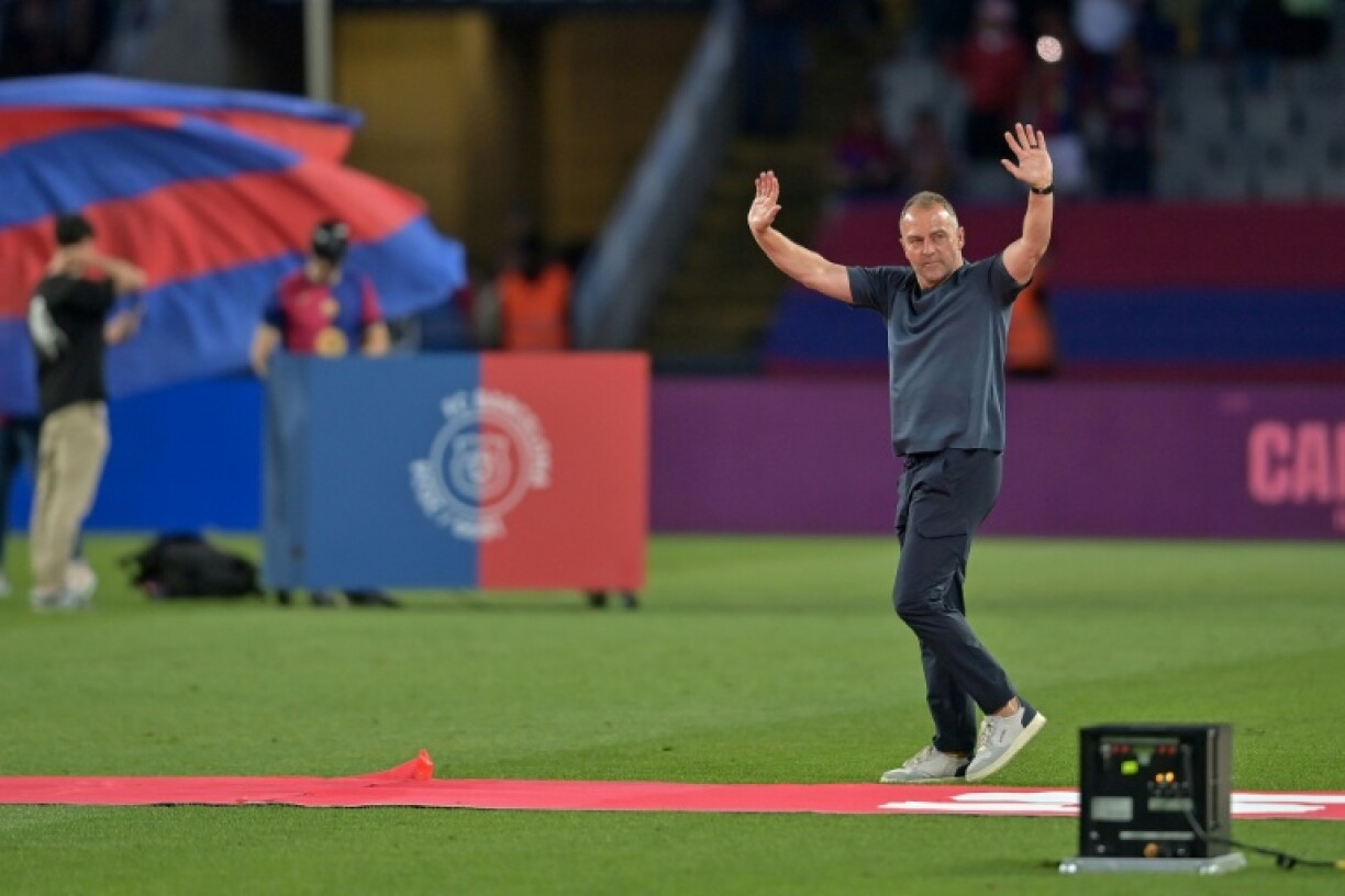Barcelona's German coach Hansi Flick waves as he celebrates their 28th Liga title