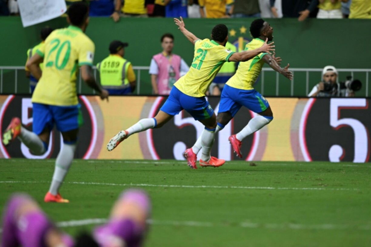 Brazil's Vinicius Jr (R) celebrates after scoring the winner against Colombia in World Cup qualifying on Thursday.