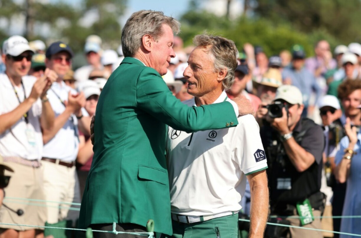 Augusta National Golf Club Chairman Fred Ridley embraces two-time Masters champion Bernhard Langer upon the German's 41st and final appearance in the event