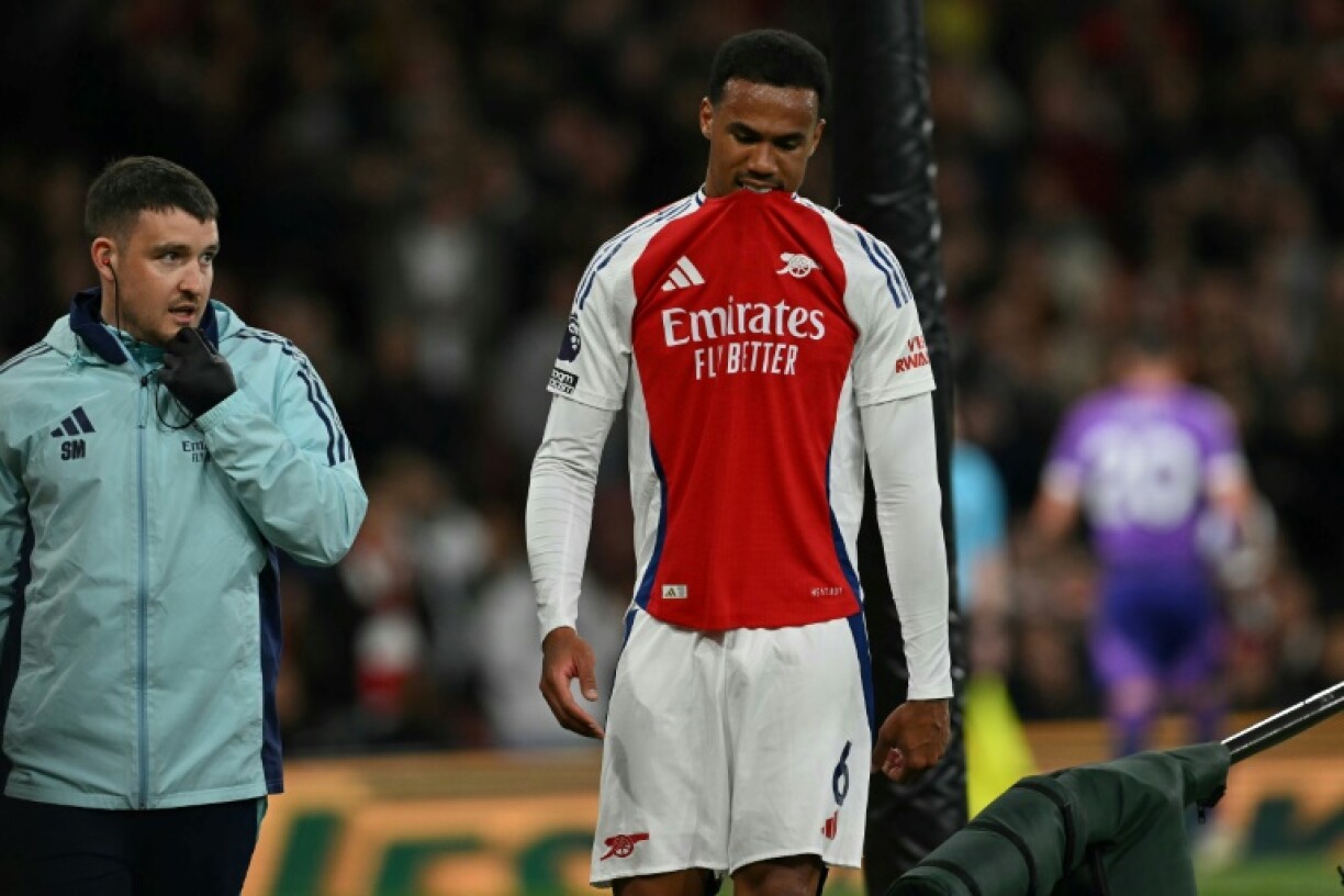 Moment of despair: Arsenal defender Gabriel Magalhaes leaves the pitch after being substituted off injured against Fulham