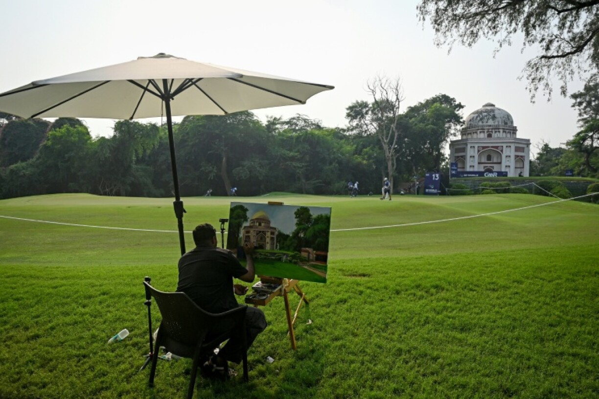 An artist paints a Mughal-era heritage monument at Delhi Golf club during the DP World India Championship