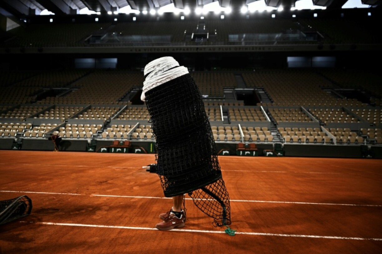 A member of the groundstaff team helps prepare the main Philippe Chatrier court at Roland Garros