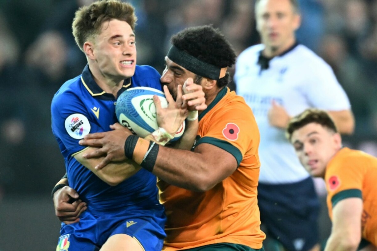 Italy's scrum-half Stephen Varney (L) in action against Australia in Udine on November 8, 2025