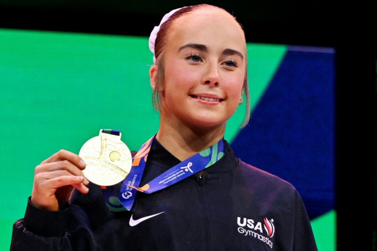 Claire Pease collects gold for the women's floor exercise in Rotterdam that helped the US finish top of the medal table