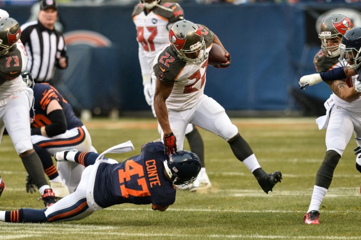 Former NFL running back Doug Martin, shown running for Tampa Bay in a 2014 game, has died at age 36