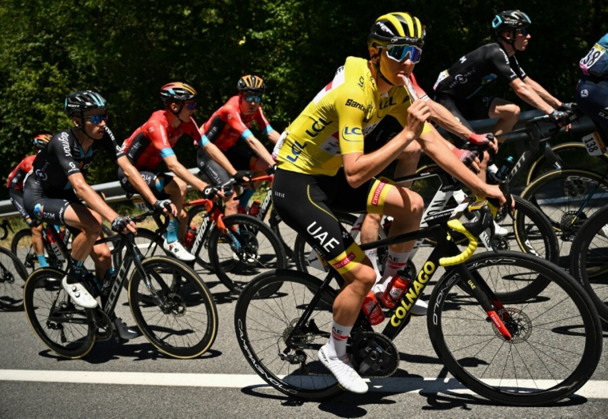 Tadej Pogacar eats on the move as he leads the 2022 Tour de France