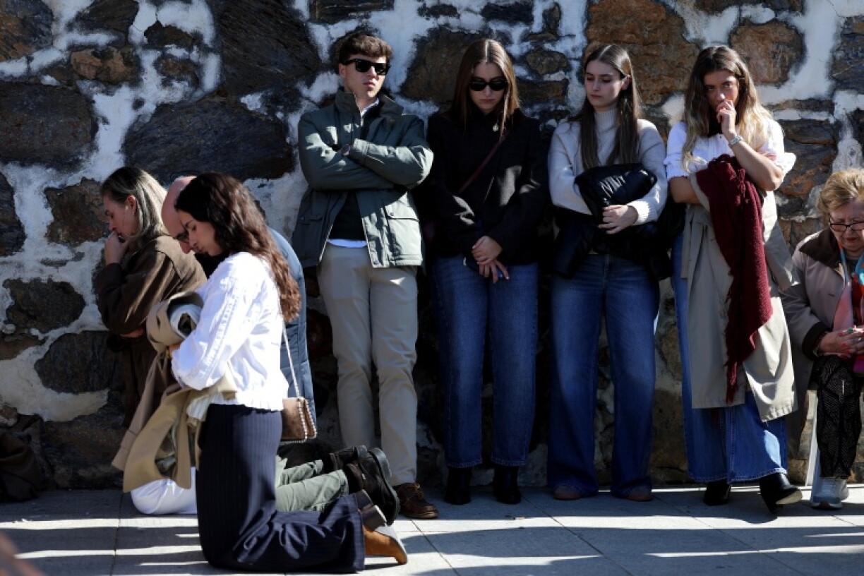 People attend the funeral mass for the victims of the rail disaster