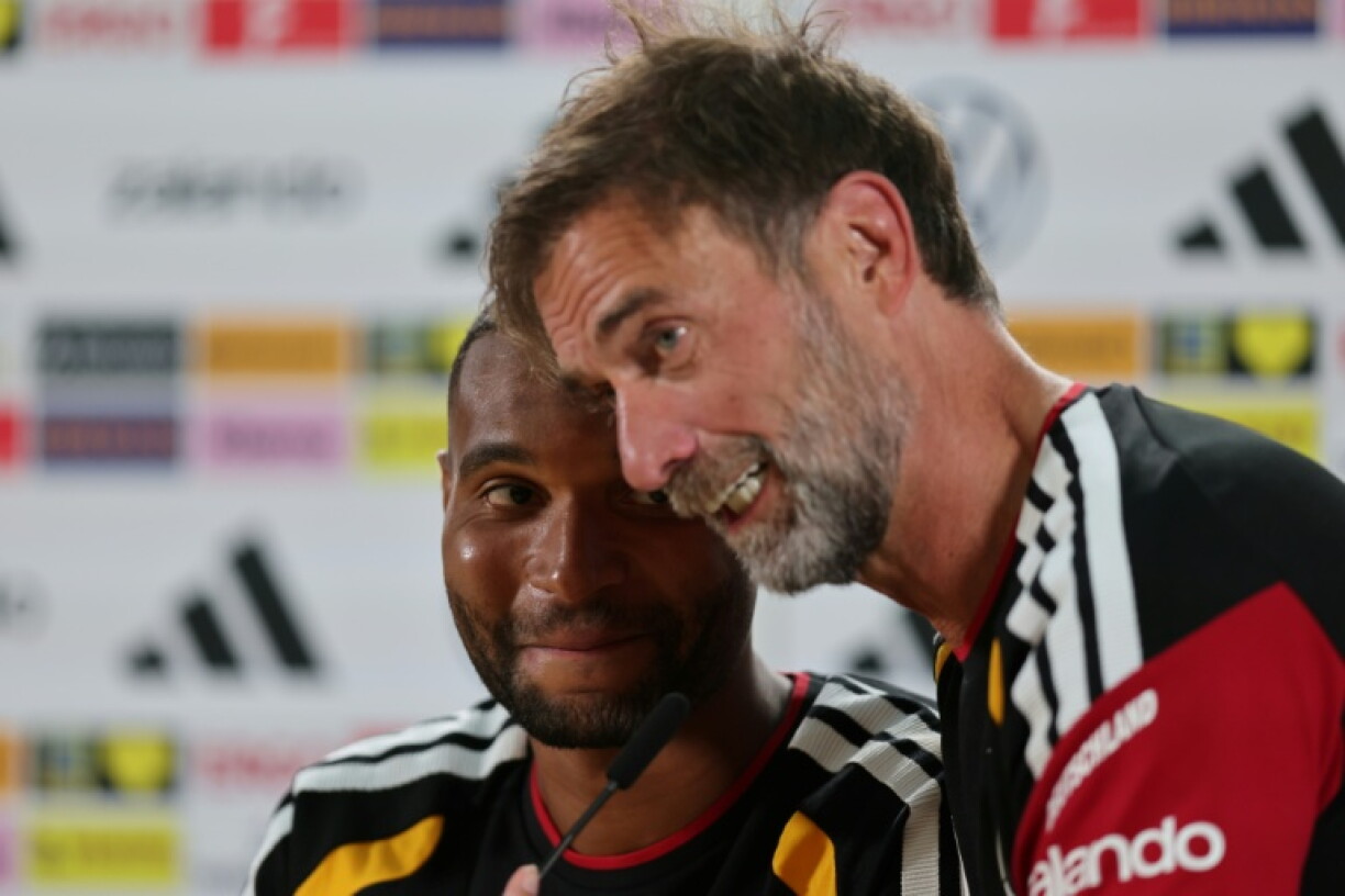 Germany defender Jonathan Tah (L) said that he could see what had made coach Jurgen Klopp (R) successful during his club career