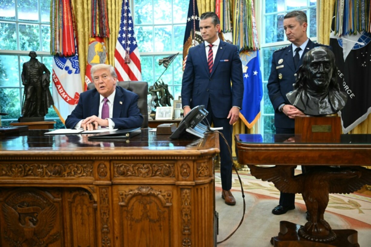 US President Donald Trump (L) speaks to reporters as Secretary of Defense Pete Hegseth (C) looks on while signing executive orders in the Oval Office of the White House in Washington, DC on September 5, 2025