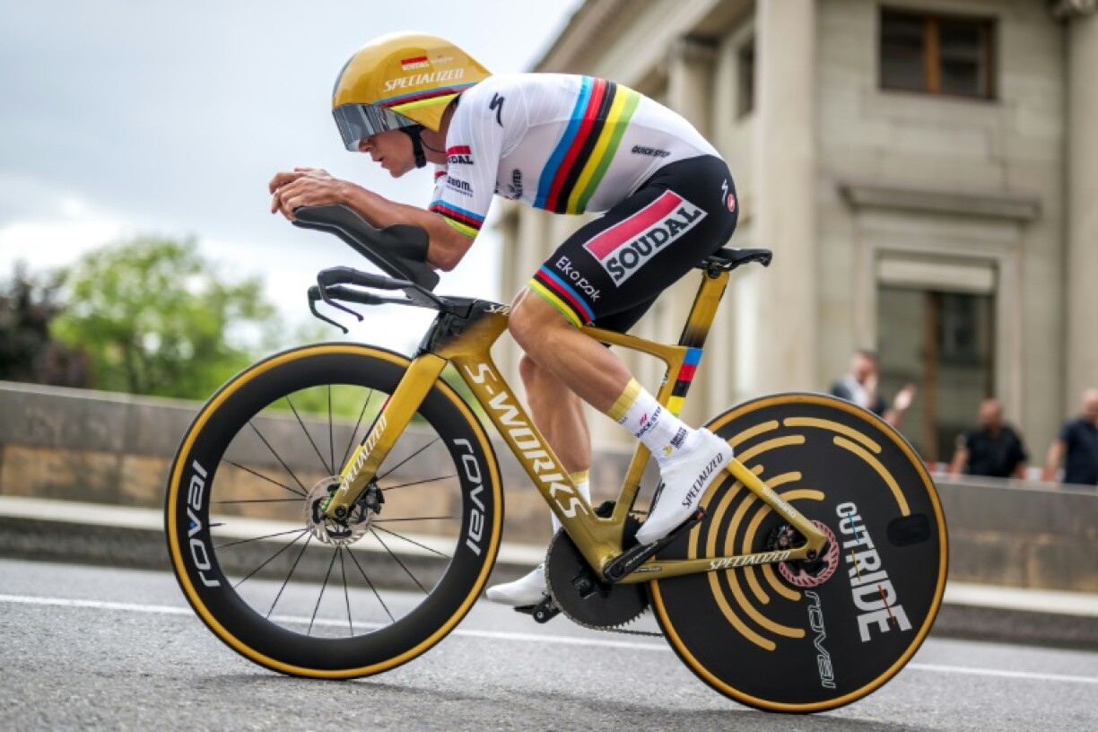 Remco Evenepoel, with a gold helmet and gold bike as Olympic champion and wearing the rainbow jersey of the world champion, rides to victory in the closing Tour of Romandie time trial in Geneva