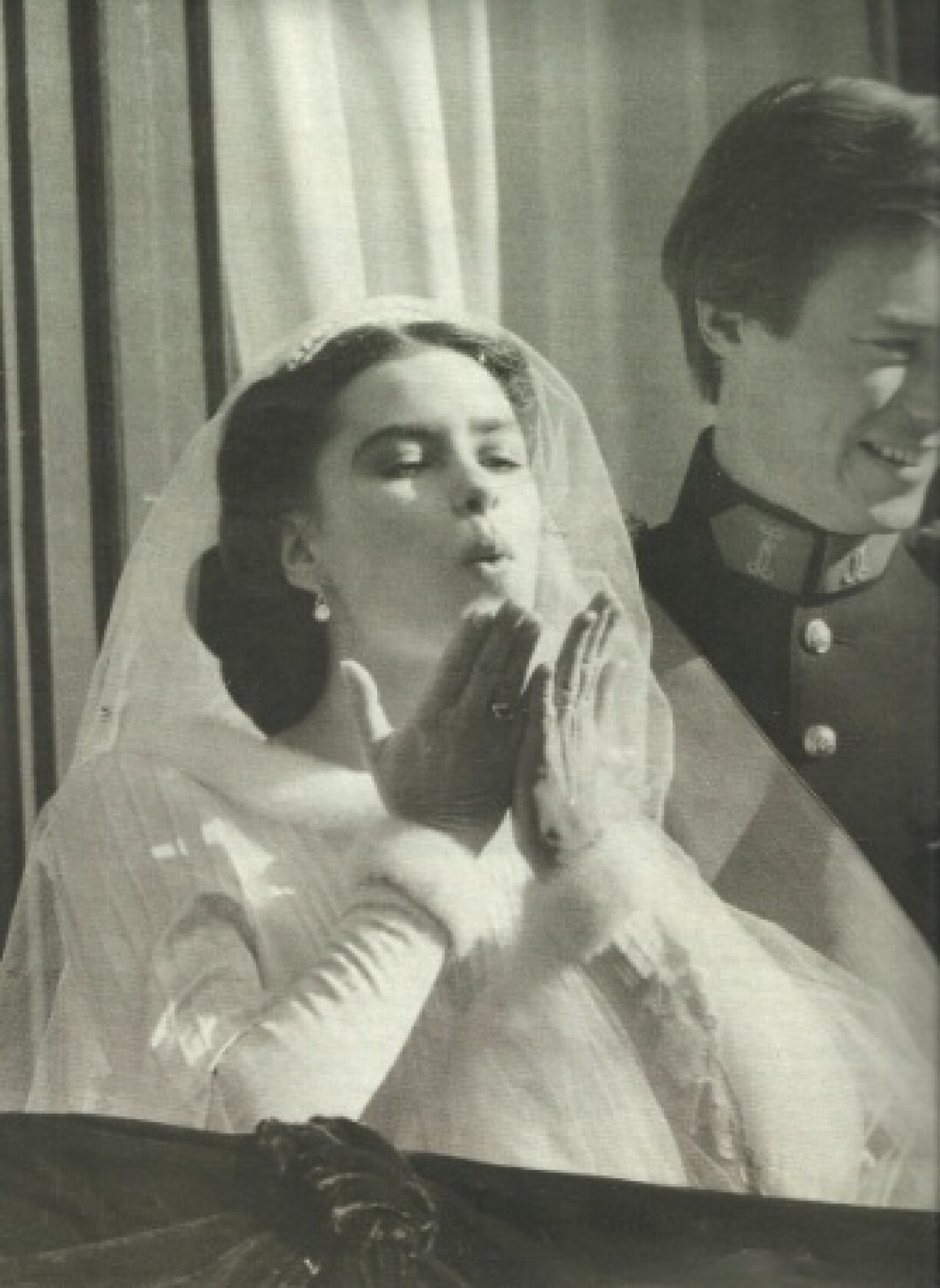 An overjoyed Maria Teresa blows kisses to the crowds from the royal balcony.