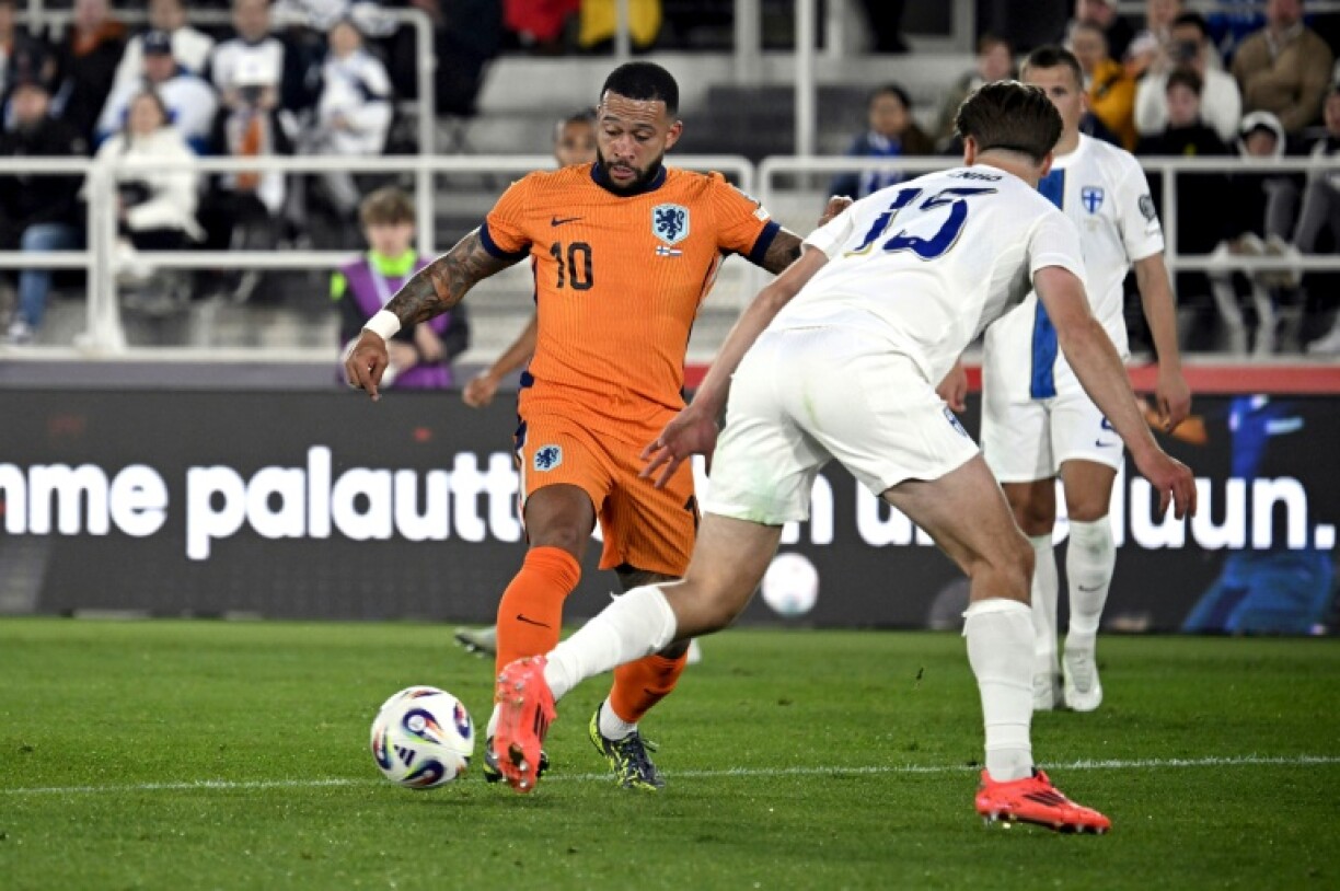 Netherlands scorer Memphis Depay takes on Finland's defender Miro Tenho
