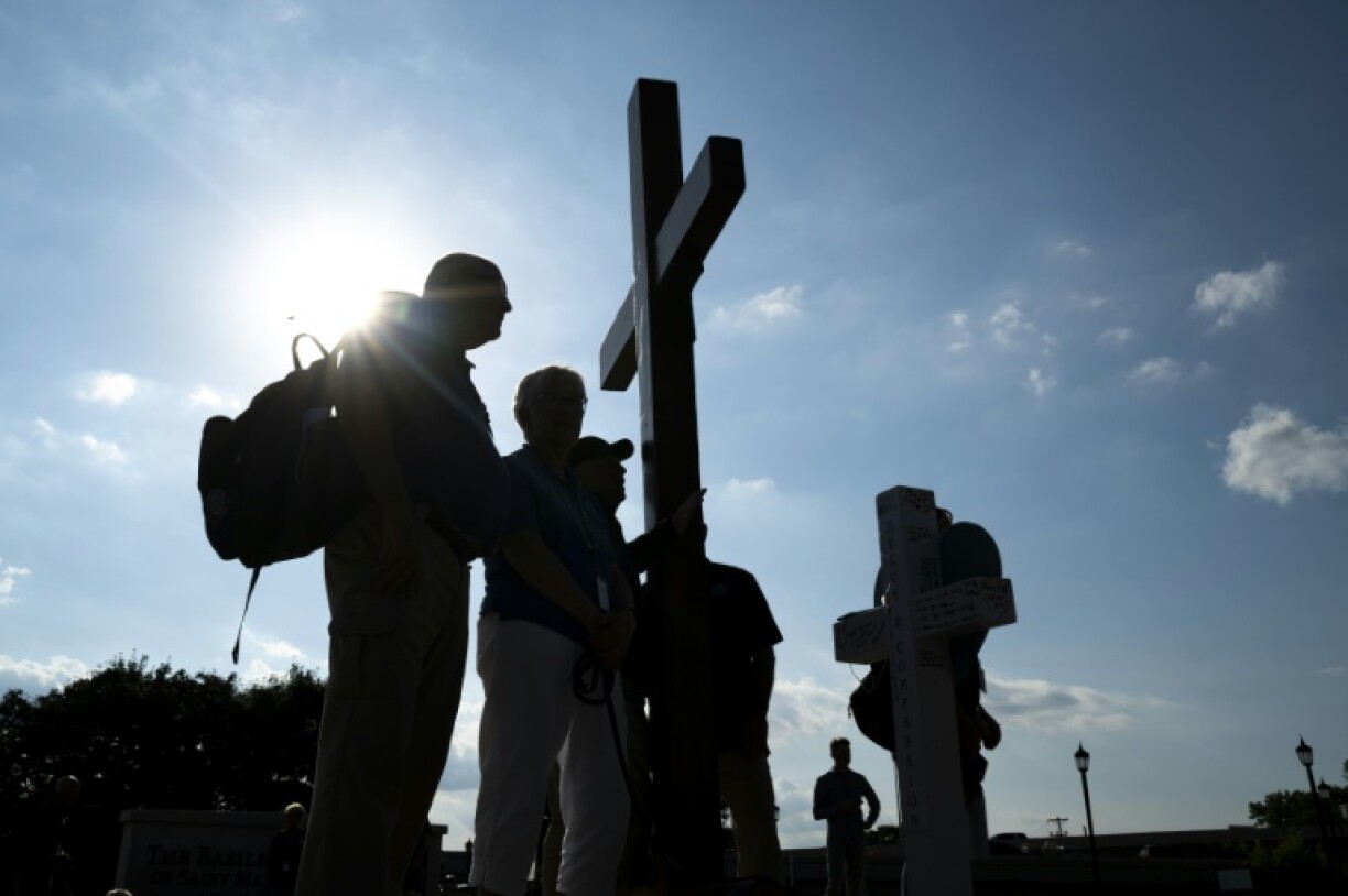 People gather outside an interfaith service at the Basilica of Saint Mary in Minneapolis, Minnesota, following a mass shooting at a local Catholic school in August 2025