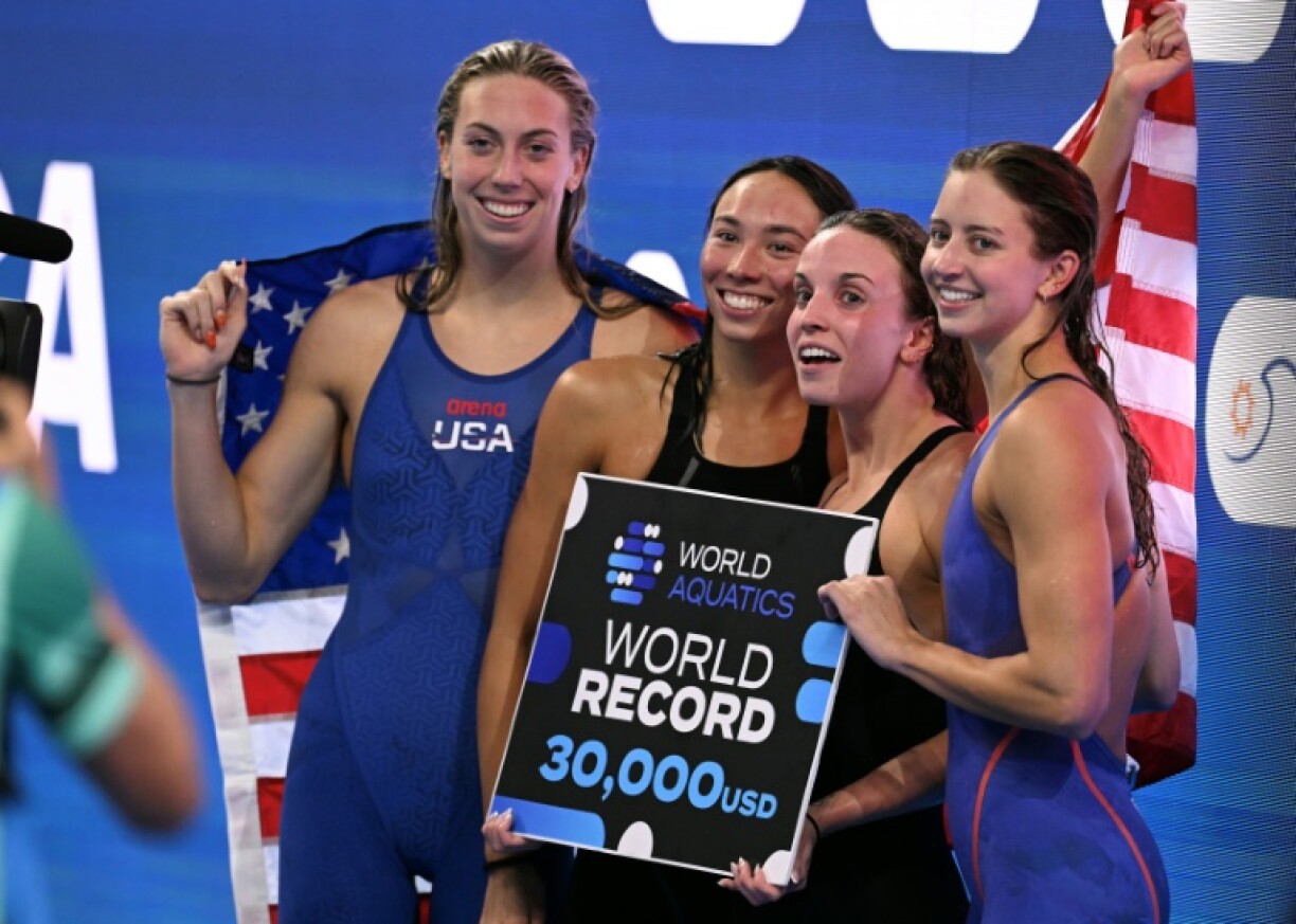 Gretchen Walsh, Torri Huske, Regan Smith and Kate Douglass celebrate after the USA broke the world record in the final of the women's 4x100m medley relay