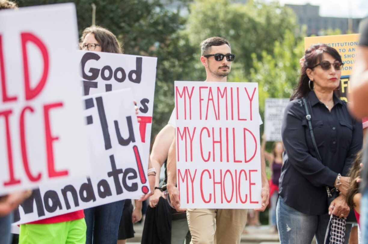 A protest against the flu vaccine in Massachusetts last year, in which several signs cited Covid
