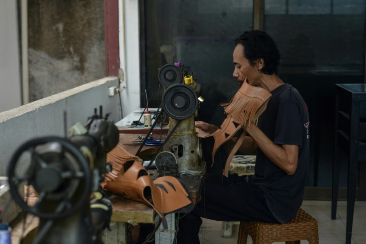 An artisan works on a pair of leather boots at the workshop of Tegep Boots in Bandung, West Java