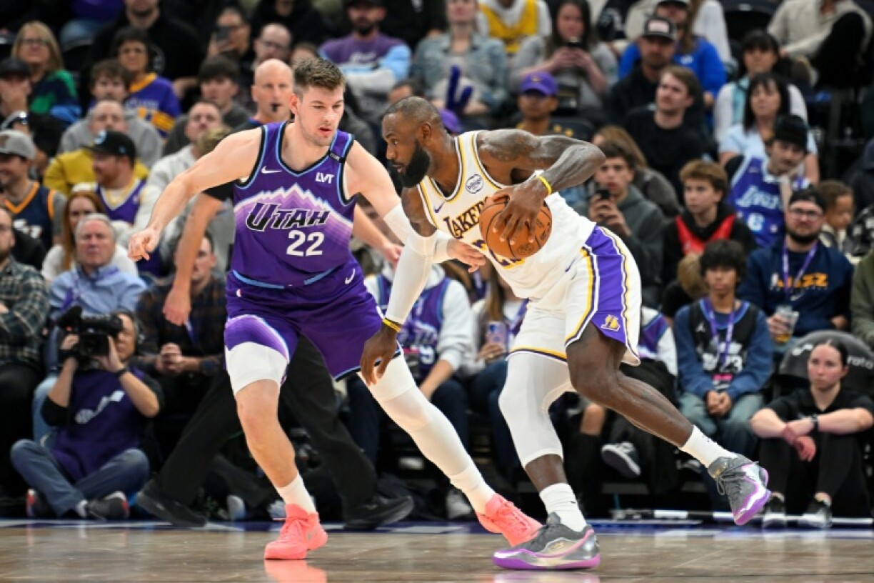 Los Angeles Lakers star LeBron James, right, in his first NBA road game of the season after a sciatica setback to start the campaign, drives to the basket against Utah's Kyle Filipowski
