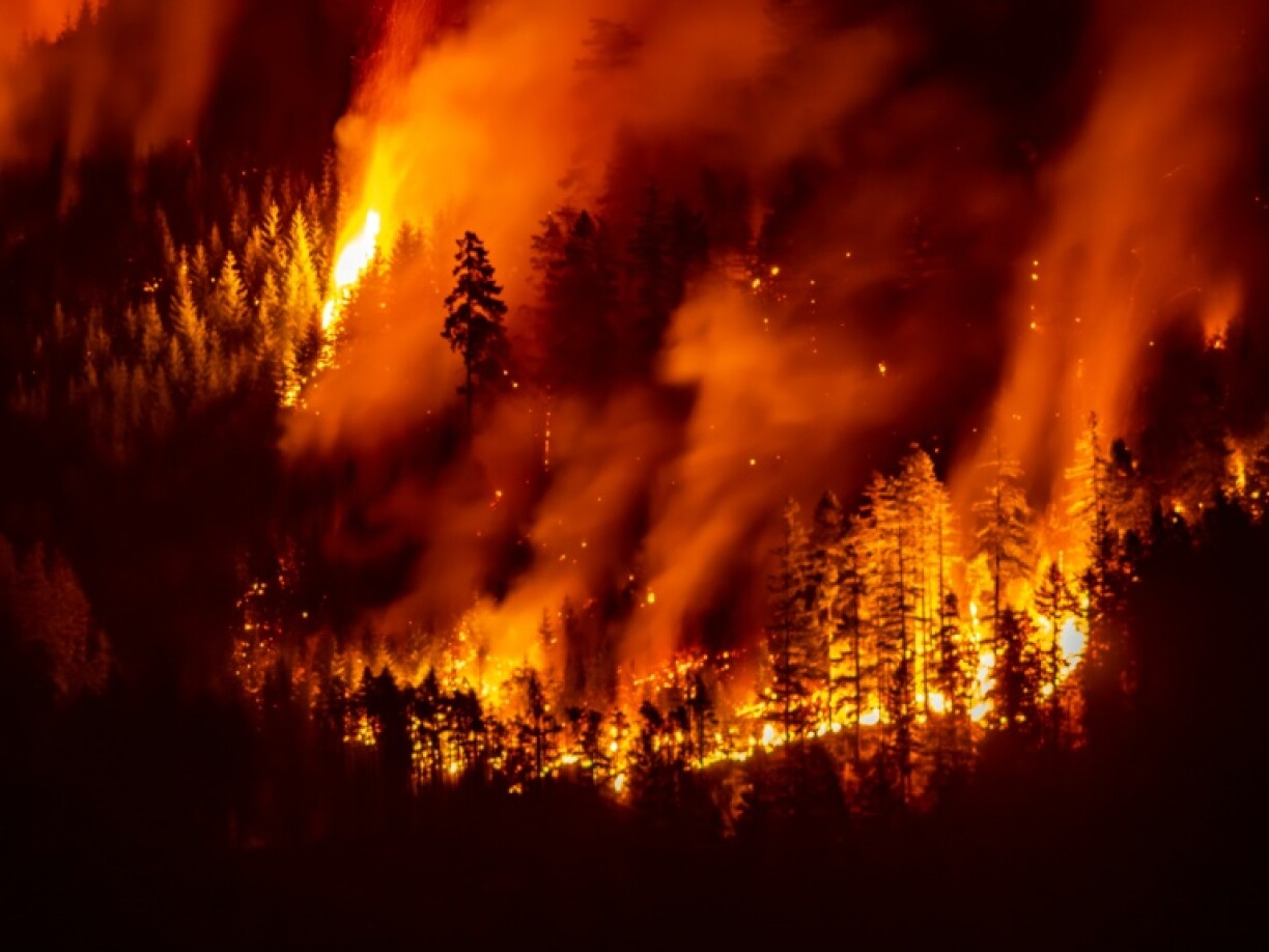 A wildfire burns on Mount Underwood near Port Alberni, on Vancouver Island, British Columbia, on August 12, 2025