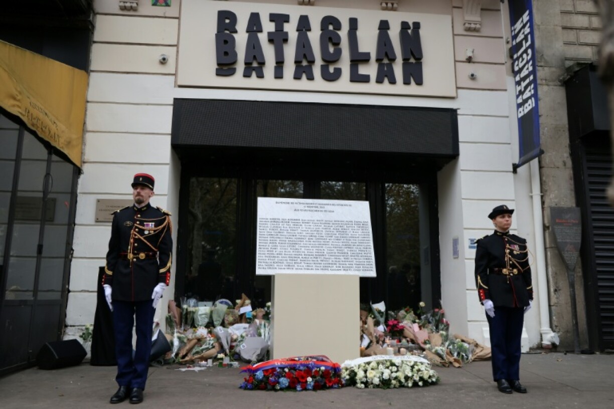Guards flank the plaque outside the Bataclan music hall in Paris commemorating those killed in attacks in November 2025
