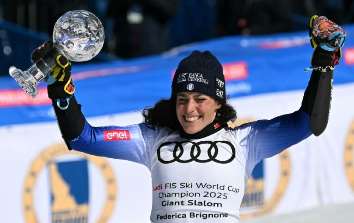 Italy's Federica Brignone celebrates with the crystal globe after claiming the World Cup giant slalom title with a runner-up finish to Lara Gut-Behrami in the season finale