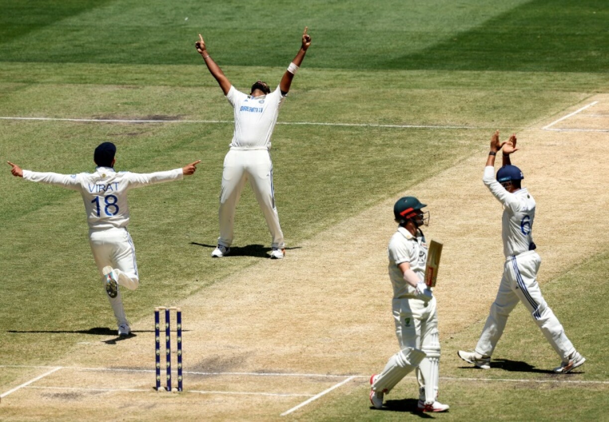 India's Jasprit Bumrah (second left) and Virat Kohli (left) celebrate the wicket of Australia's Travis Head