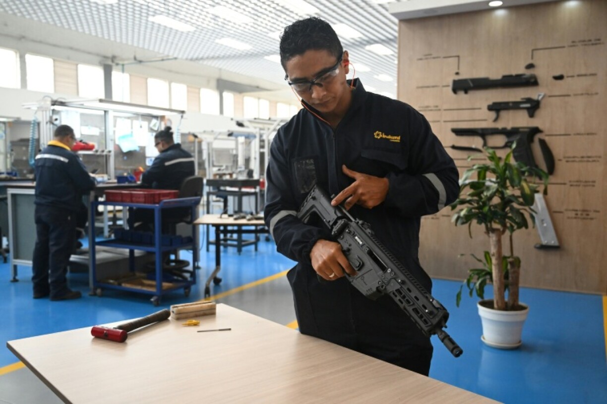 An engineer shows a new rifle designed and manufactured in Colombia
