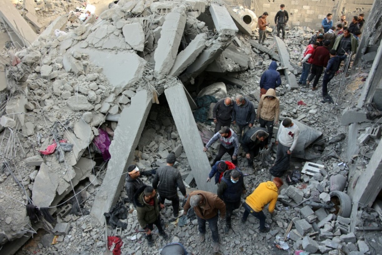 Civilians check the site of an Israeli strike in Jabalia, in north Gaza