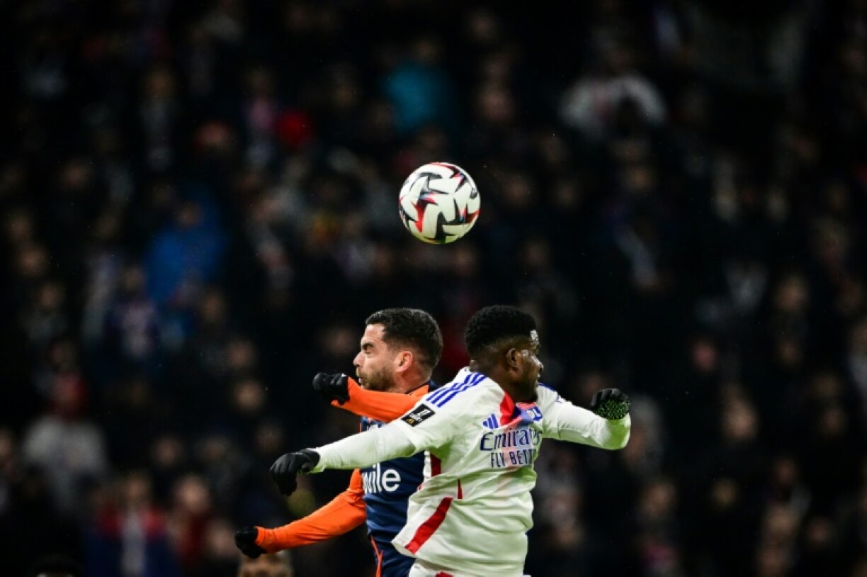 Lyon's Ghanaian forward Ernest Nuamah (R) fights for the ball with Montpellier midfielder Teji Savanier in French Ligue 1