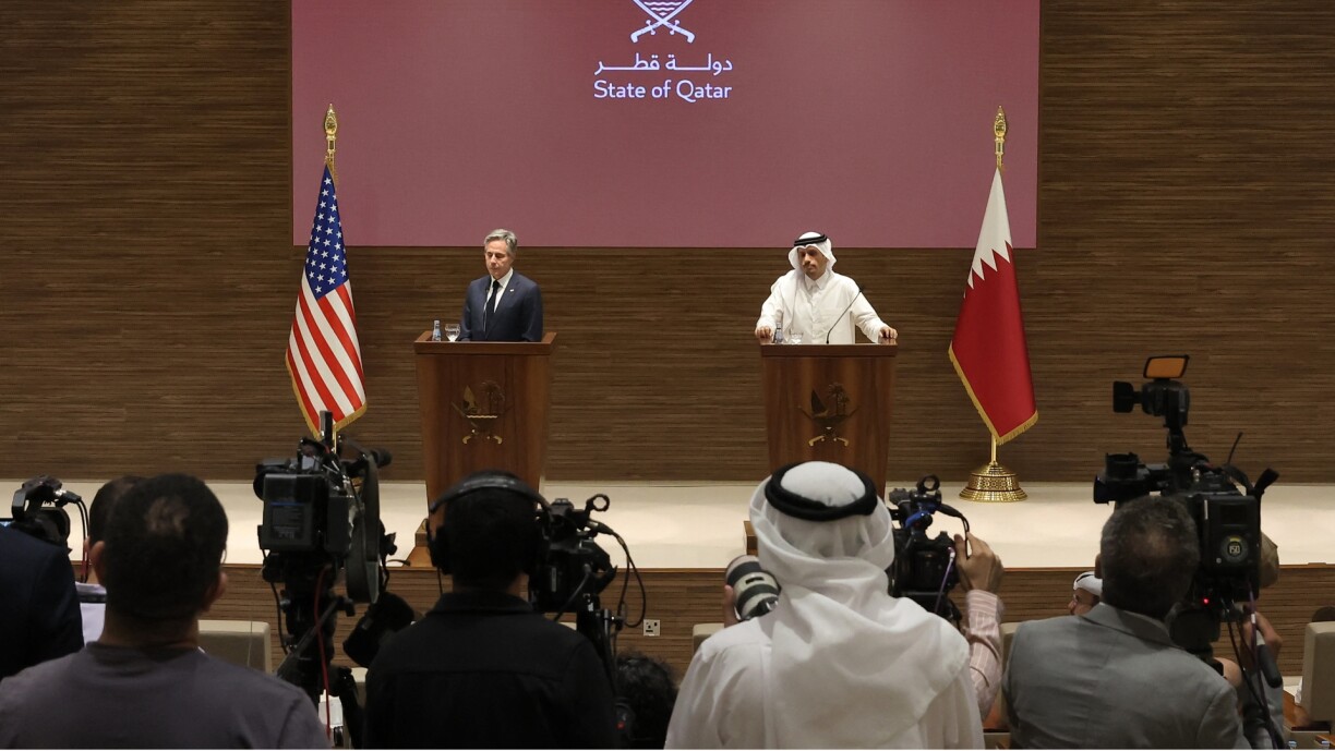 Journalists film as Qatar's Prime Minister and Foreign Affairs Minister Sheikh Mohammed bin Abdulrahman bin Jassim al-Thani and US Secretary of State Antony Blinken give a joint press conference in Doha on 24 October.