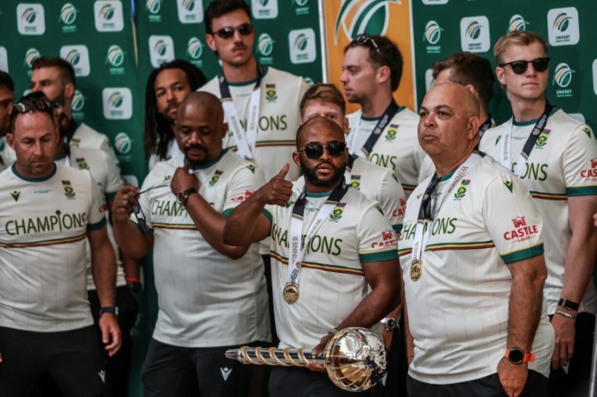 South Africa captain Temba Bavuma (C) with teammates after arriving in Johannesburg