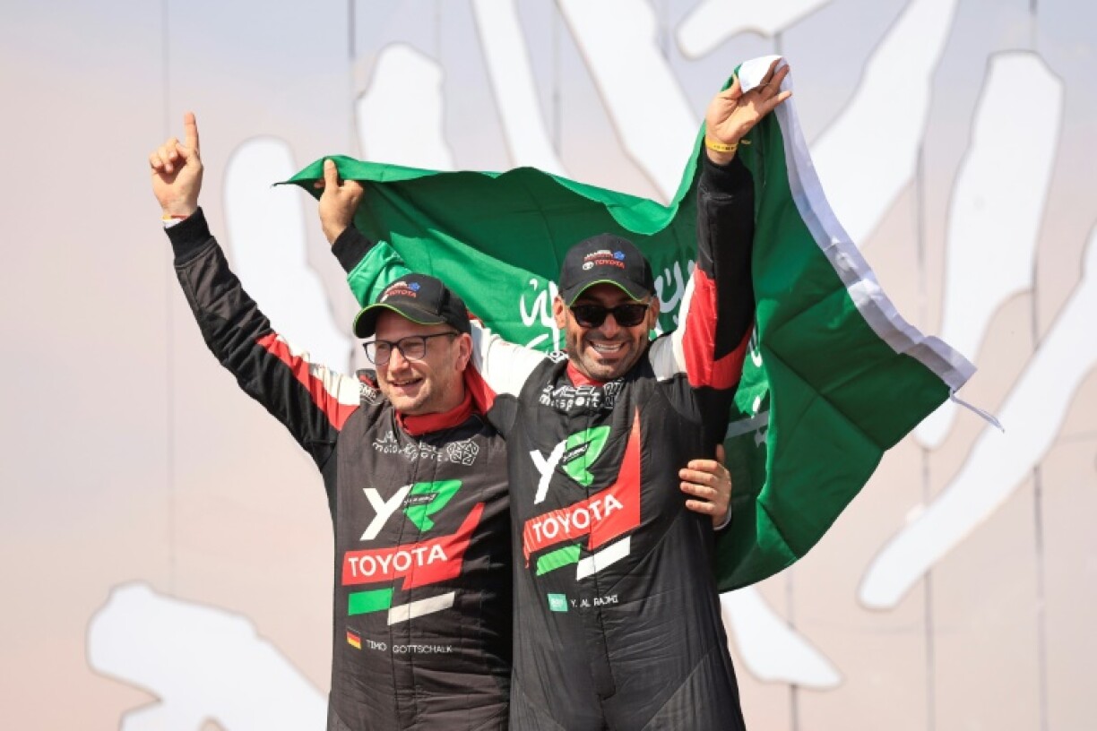 Saudi driver Yazeed Al Rajhi (R) and co-driver Edouard Boulanger (L) celebrate after winning the Dakar Rally