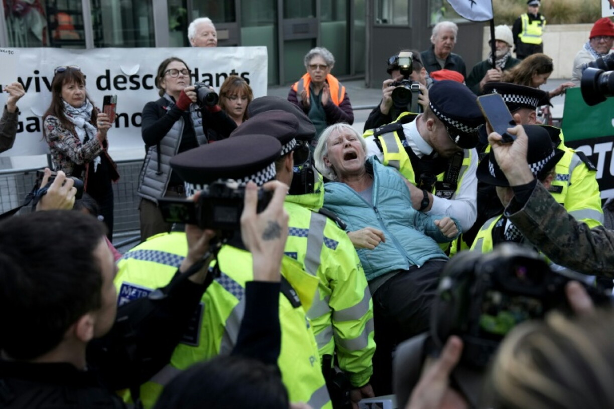 A pro-Palestinian activist is carried away by police officers after being arrested Saturday during a protest in support of the proscribed group Palestine Action outside the US Embassy in London