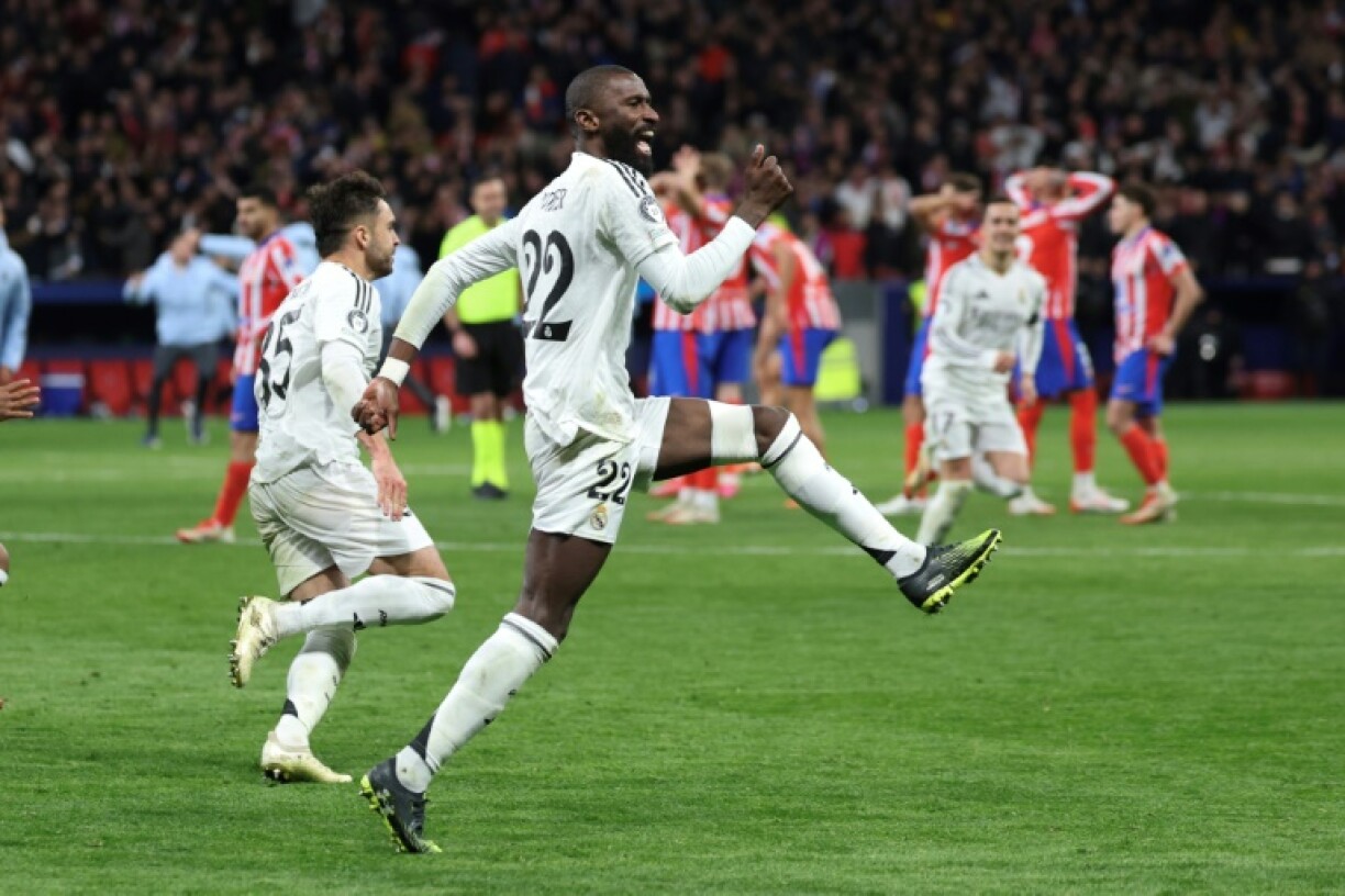 Antonio Rudiger (R) celebrates after scoring the penalty which took Real Madrid through to the Champions League quarter-finals at Atletico's expense