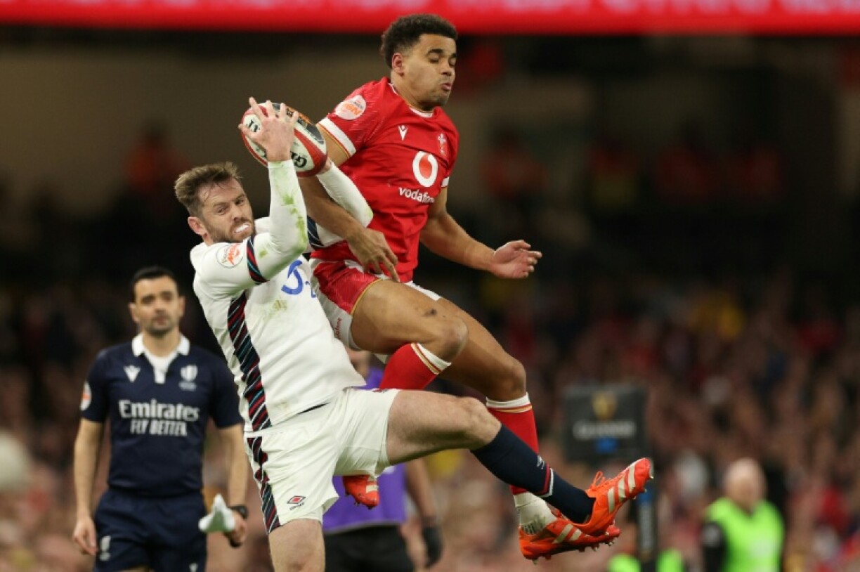 England's Elliot Daly (L) beating Ben Thomas of Wales to a high ball during the Six Nations in March