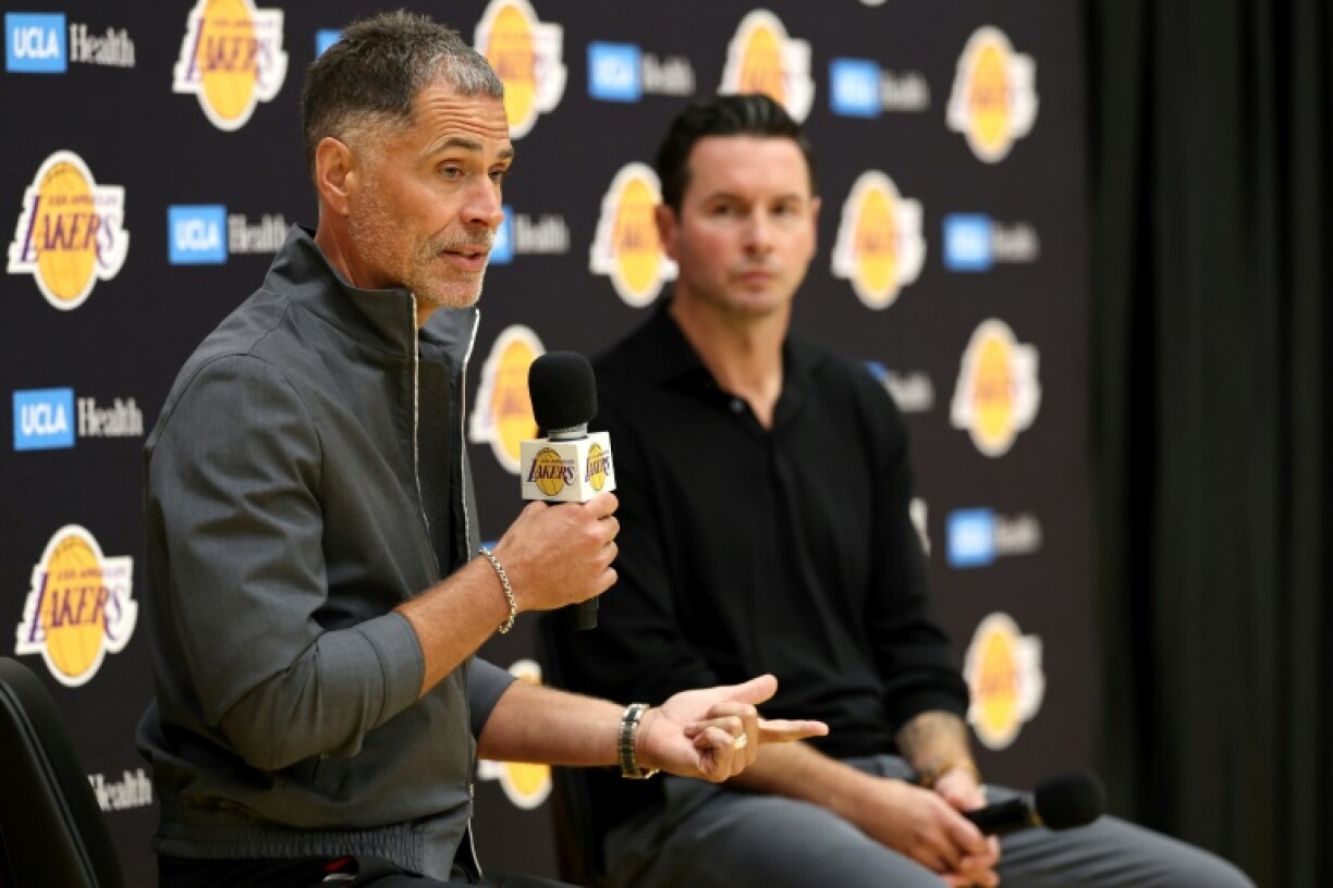 Los Angeles Lakers president of basketball Rob Pelinka (left) announces a contract extension for head coach J.J. Redick (right)