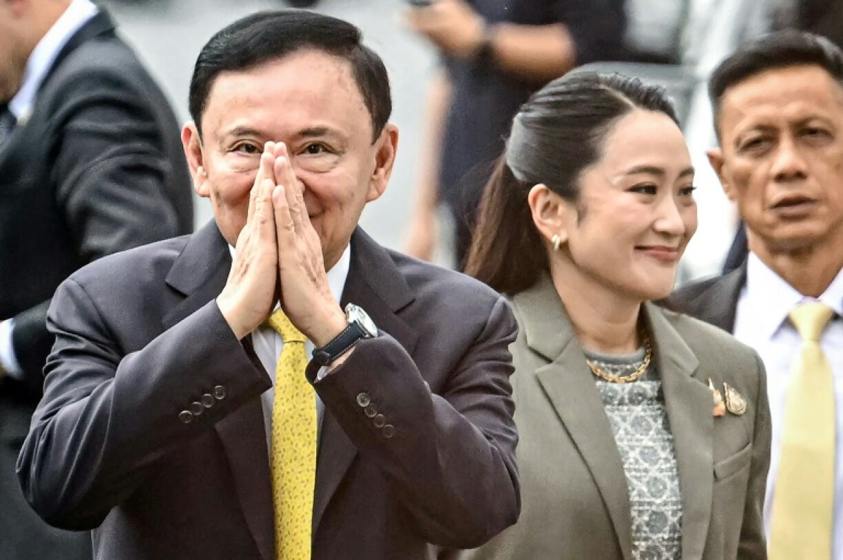Thaksin greets supporters at the Supreme Court in Bangkok ahead of the verdict