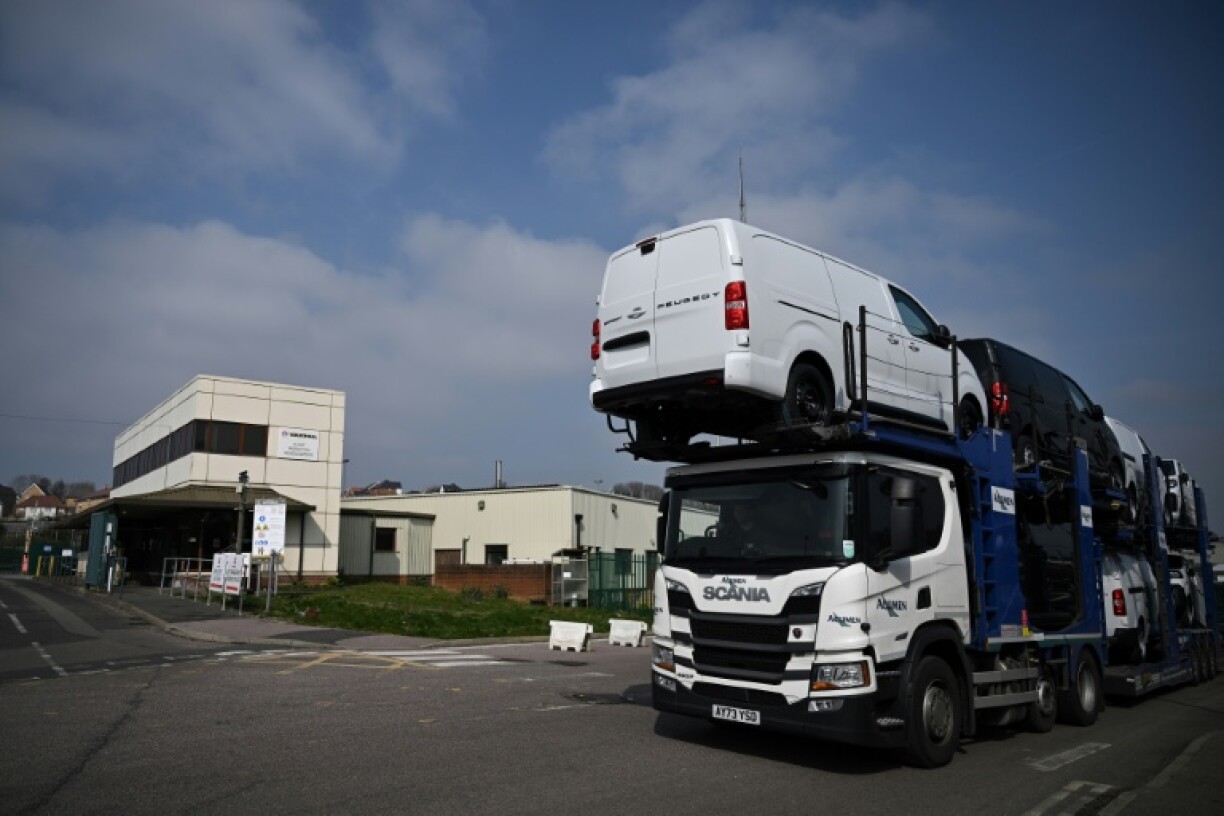 A lorry transports new vehicles outside the Vauxhall factory, in Luton, north of London