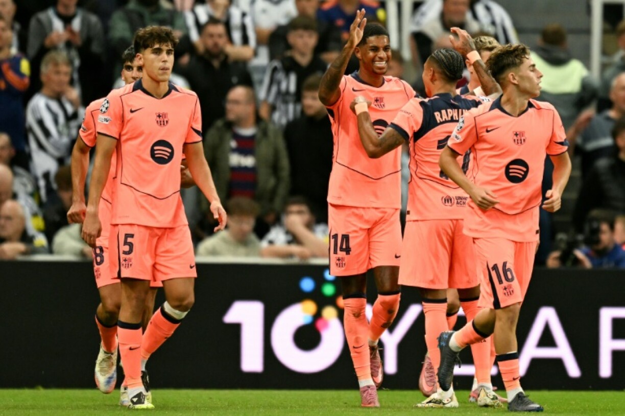 Barcelona's Marcus Rashford (C) celebrates after scoring against Newcastle