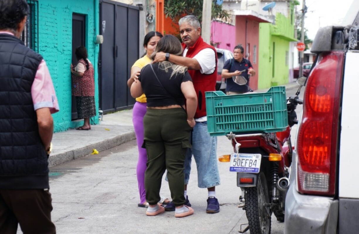 Residents comfort each other after the attack during a religious festival
