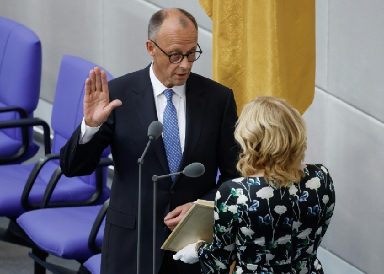 German Chancellor Friedrich Merz takes the oath from the president of the lower house of parliament, Julia Kloeckner