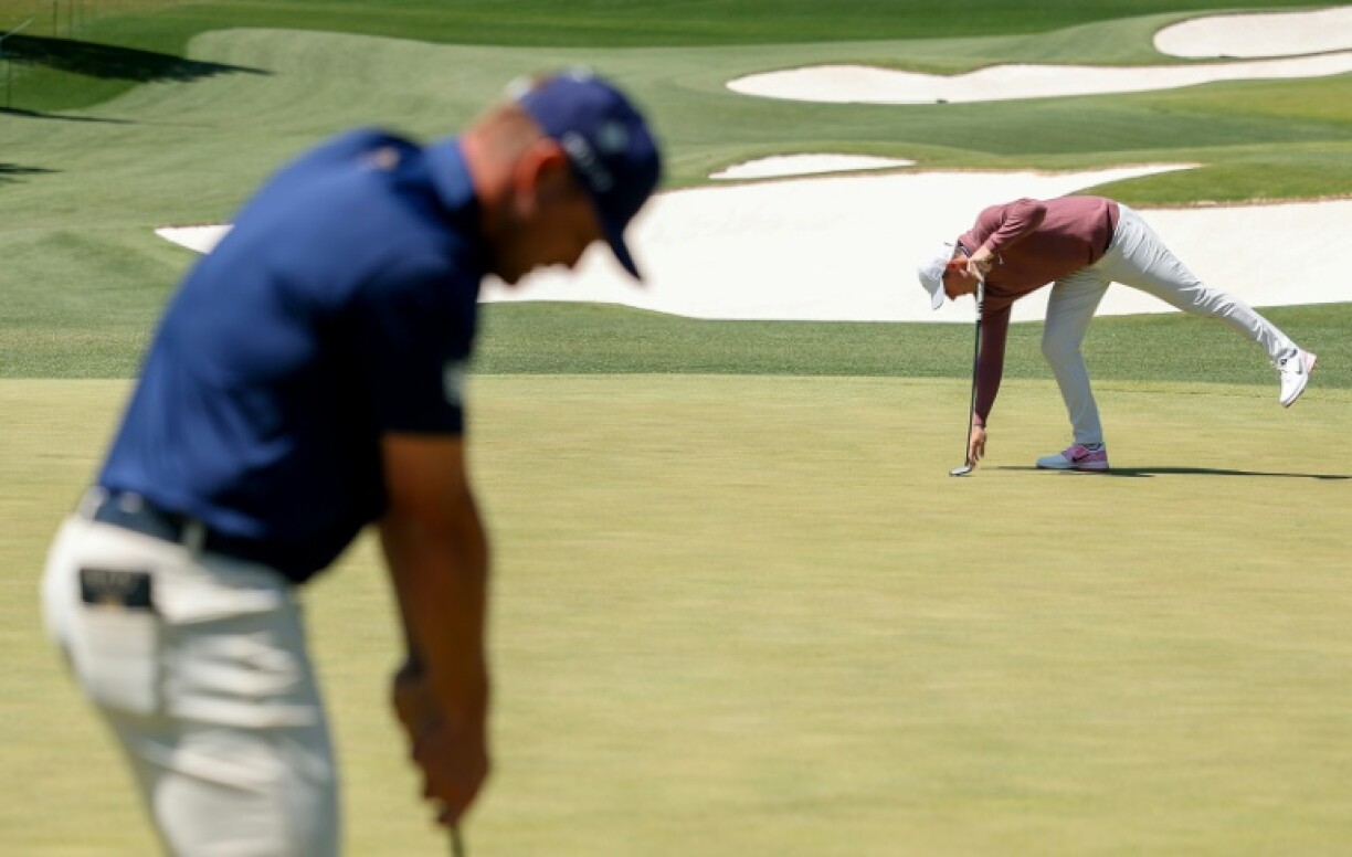 Bryson DeChambeau, left, and Rory McIlroy prepare for their final round at the Masters at Augusta National